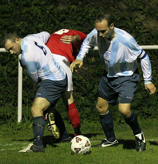 Richard Maymon (6) and Colin Moss tackle Andy Boxall near the corner flag
