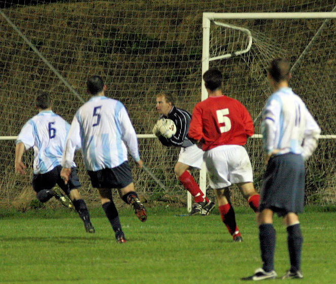 Simon Clayton deals with another Worthing Utd attack
