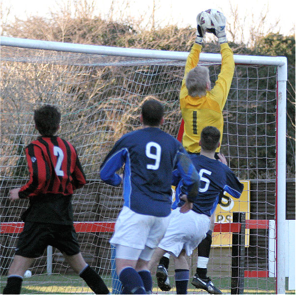 Tom Rand collects a cross before Dave Adams (9) and Nathan Godden (5) get there
