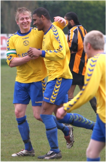 ... and is congratulated on his hat trick by Chi's captain Alex Ward
