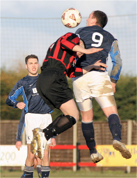 Hassan Yassan challenges Dave Adams in the air
