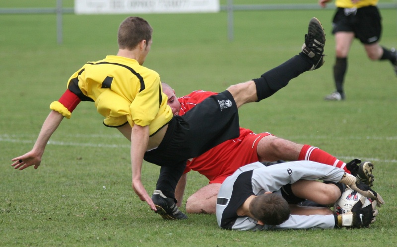 Brave keeping from Jon Hendricks as he dives between Chris Yelling and Luke Jones
