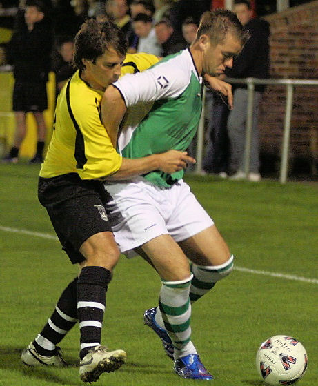 Brett Forden shields the ball from Stuart Smith
