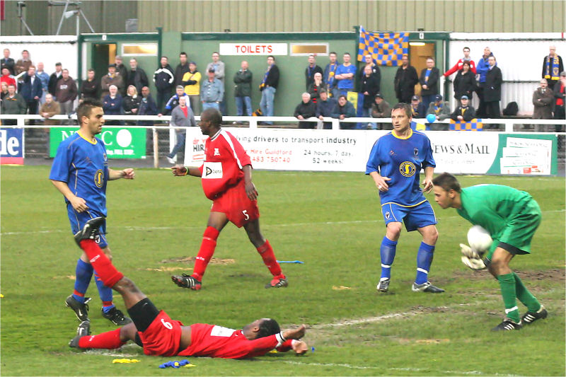 Danny Naisbitt collects the ball but Mark Nwokeji has gone down in the box ...
