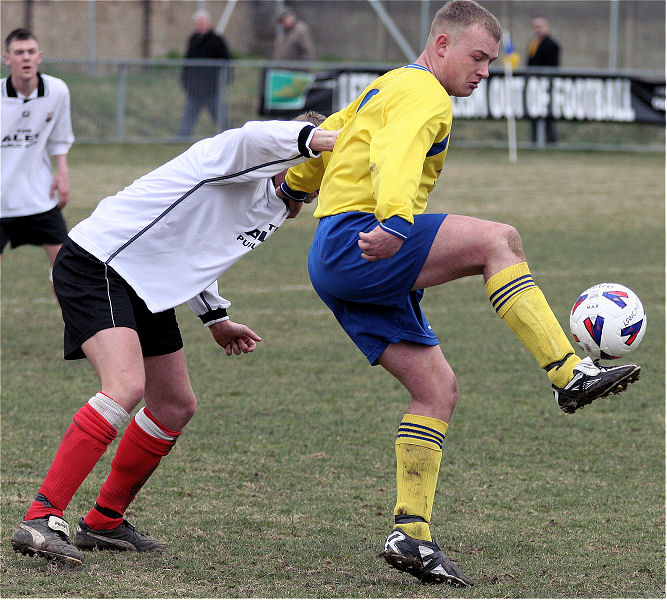 Terry Streeter controls the ball watched by James Heller
