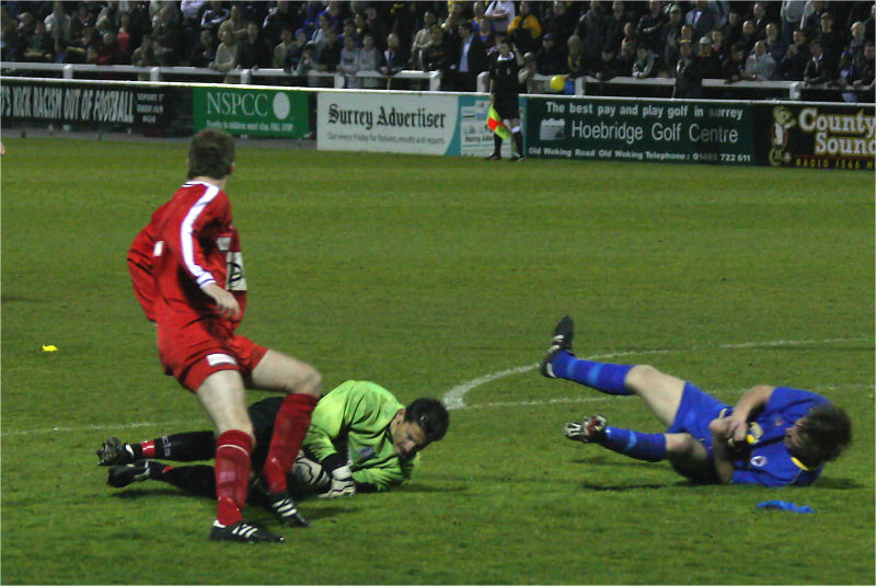 Nick Gindre saves and Richard Butler, racing in, takes a tumble
