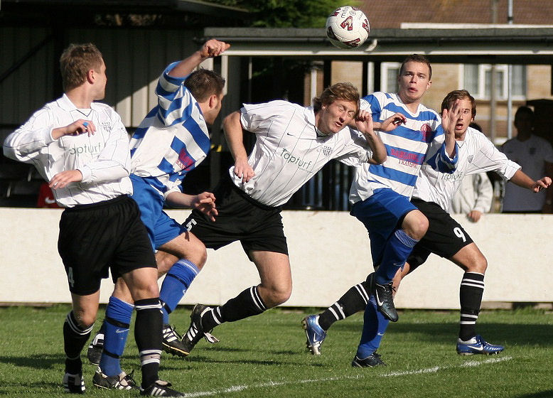 Jay Head dives for the ball between defenders
