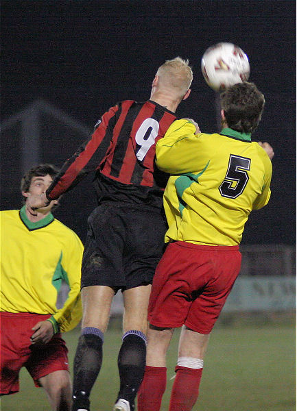 Kane Evans (9) and Stuart Faith (5) compete for a header
