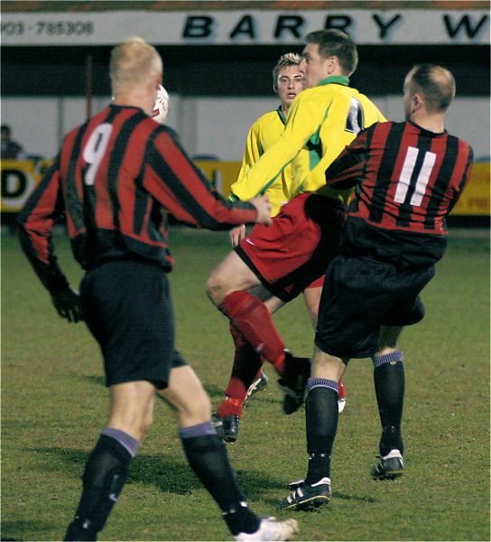 Chris Hewitt clears the ball before Kane Evans (9) and Darren Annis (11) get there
