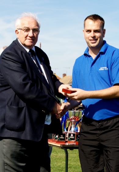 Manager Gareth Davies receives his championship medal from Peter Bentley
