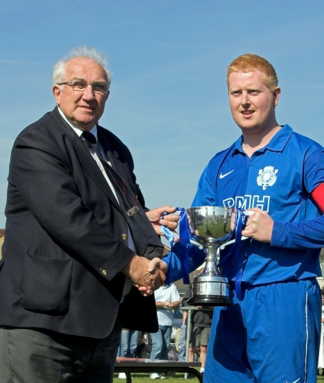 Captain Russ Tomlinson collects the SCFL Division 3 championship trophy from Peter Bentley
