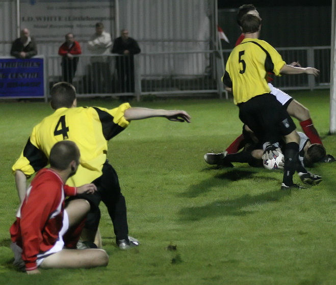 Jon Hendricks grabs the ball from the feet of Dave Walker with Rob May backing up
