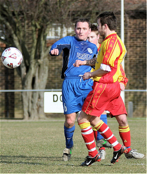 Dave Oakes gets the ball away from Kevin Marchesi
