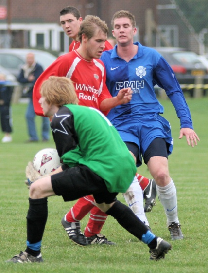 Shayne Goldsmith grabs the ball ahead of Andy Smart
