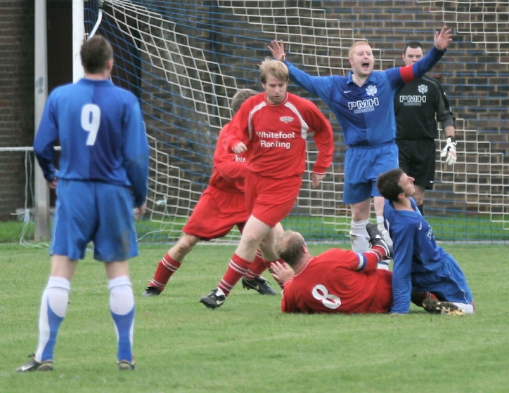 Russ Tomlinson yells for a free kick for this tackle by Dave Connor on Adam Bibb
