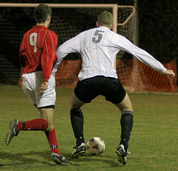 Chris Hazell keeps the ball away from Dave Walker
