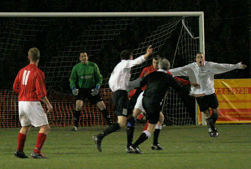 The ball has hit Jim Smith, Sonny Banks and Josh Biggs appeal for a penalty, not this time
