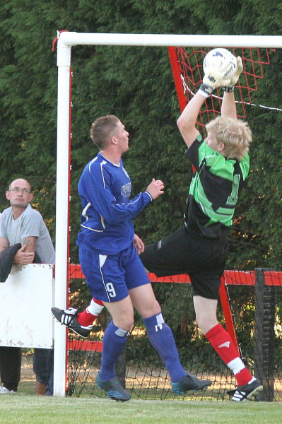 Wick keeper Tom Rand gathers the ball safely with Andy Smart close by
