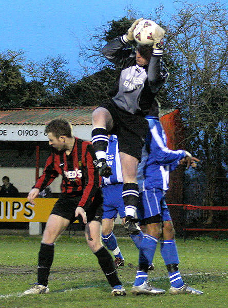 Alan Mansfield cuts out a high cross
