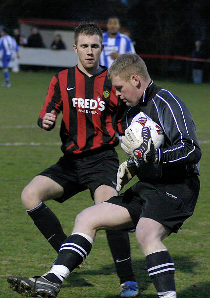 Alan Mansfield grabs the ball before Danny Curd can get there
