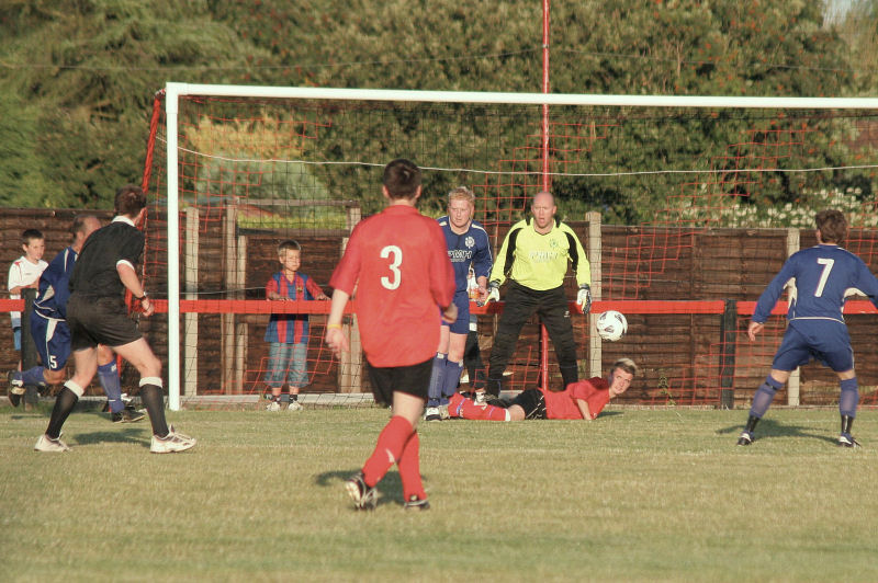 Russ Tomlinson, Matt Grieves, Tom Bird (3) and Ryan Morten (7) watch as Wick's Lewis Gibbs goes down in the box but referee Rob Wilkins gives nothing
