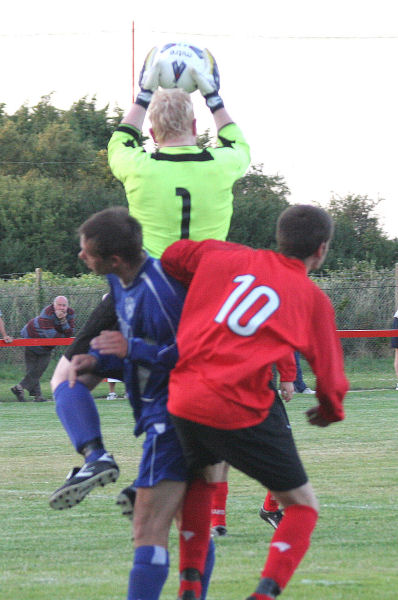 Stand-in keeper Russ Tomlinson collects the ball as Kevin Clayton blocks Dan Jarvis (10)
