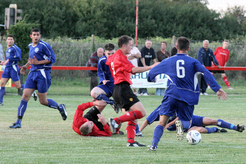 Wick's Haydn Aldred and Kevin Clayton (6) scramble for the ball
