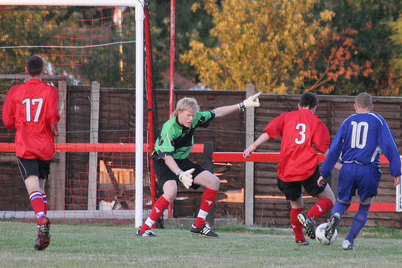 Keeper Tom Rand tells Tom Bird (3) where he wants the ball put with James Highton (10) running in
