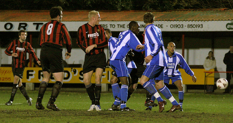 ... and the players watch as the ball goes to the keeper
