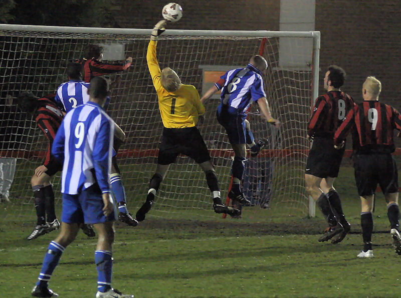 Tom Rand tips the ball away from Daren Pearce ...
