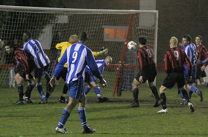 ... and Pete Christodoulou scrambles the ball away
