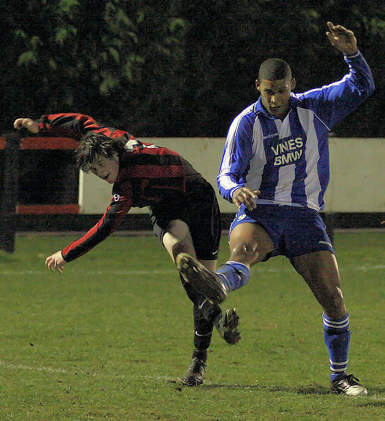 Kieron Howard clears from Chamal Fenelon
