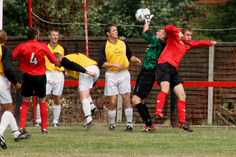 Borough keeper Seb Barton collects challenged by Danny Curd with Chris Morrow (4) and Ben Austin close by
