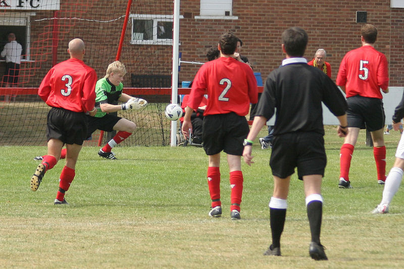 Tom Rand saves again with Stuart Townsend (3), Ollie Howcroft (2) and Dave Turner (5) close by
