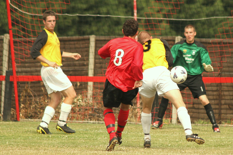 This shot by Marc Cooper (8) is cut out by Stuart Tuck (3) and Seb Barton with Ben Austin on the post
