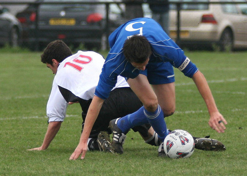 Martyn Flack gets the ball away from Michael Frangou
