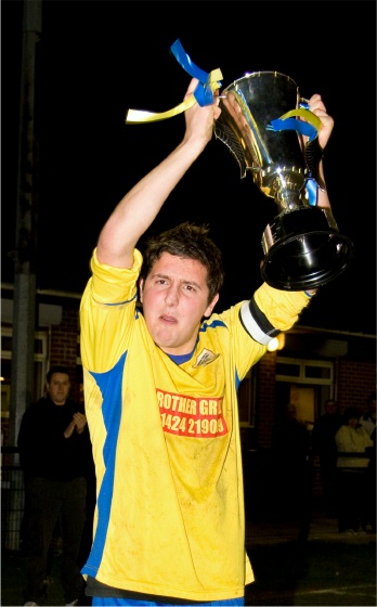 Bexhill United captain Warren Parsons lifts the Sussex Intermediate Cup
