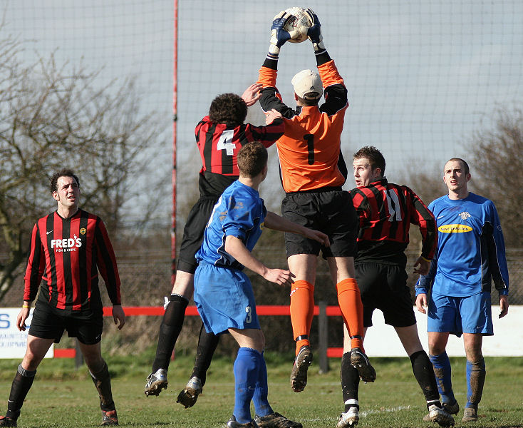 Simon Davey gets to the ball before Chris Morrow and Danny Curd
