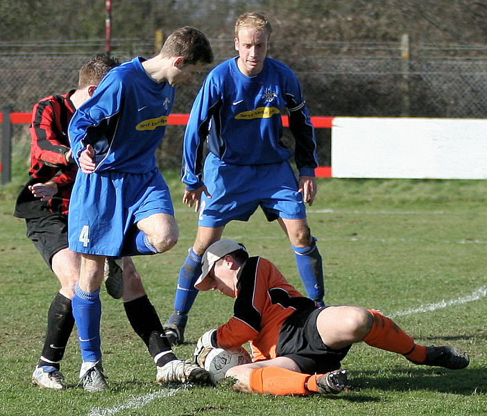 Simon Davey grabs the ball right on the edge of his area
