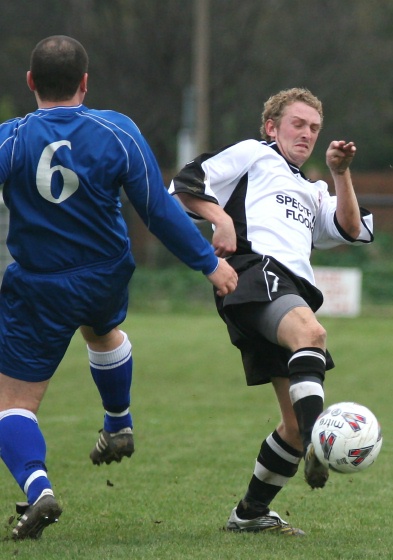 Callum Britton gets the ball away from Stuart McCall
