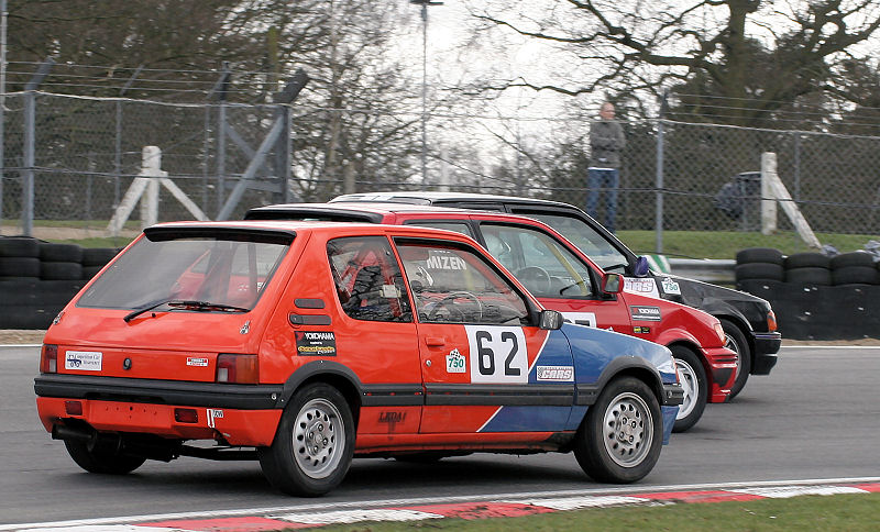 Dave Wright (62) pushes his Peugeot up the inside at Druid's
