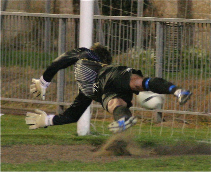 Pottage keeper Andy Foulkes is just beaten by Dan Barnard's penalty on 70 minutes
