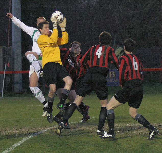 Matt Willard collects before Scott Tipper can get to the ball
