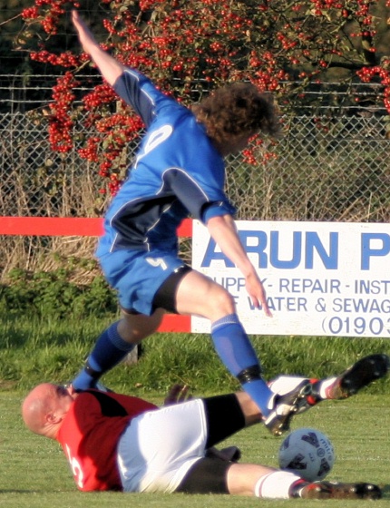 OUCH!!  Tony Miles tackles Roy Pook and is caught by the trailing leg
