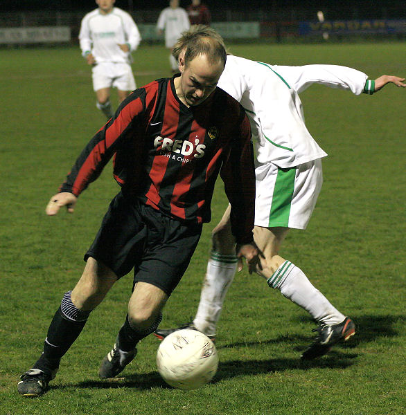 Darren Annis takes the ball past a defender
