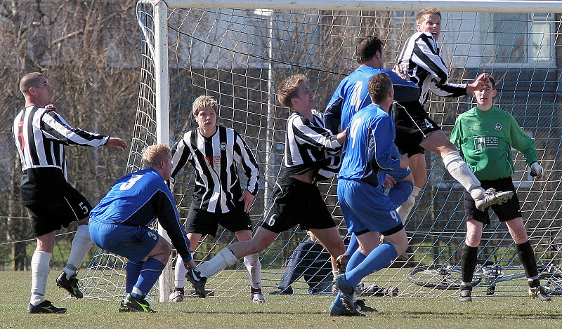 Ashley Jones heads away with Brett Neal and Andy Smart challenging
