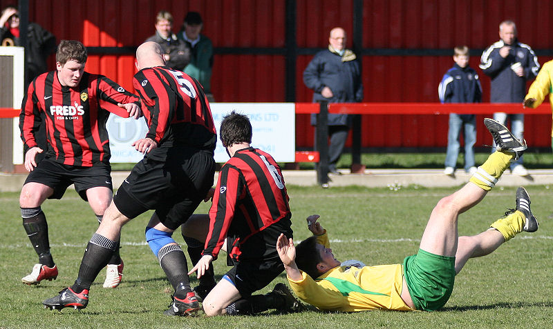 Lee Howard, Tony Miles and Dave Sharman combine to deny Peter Cooper
