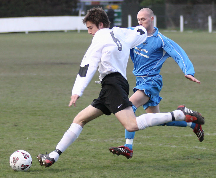 Chris Watton on the ball tracked by Matt Follows
