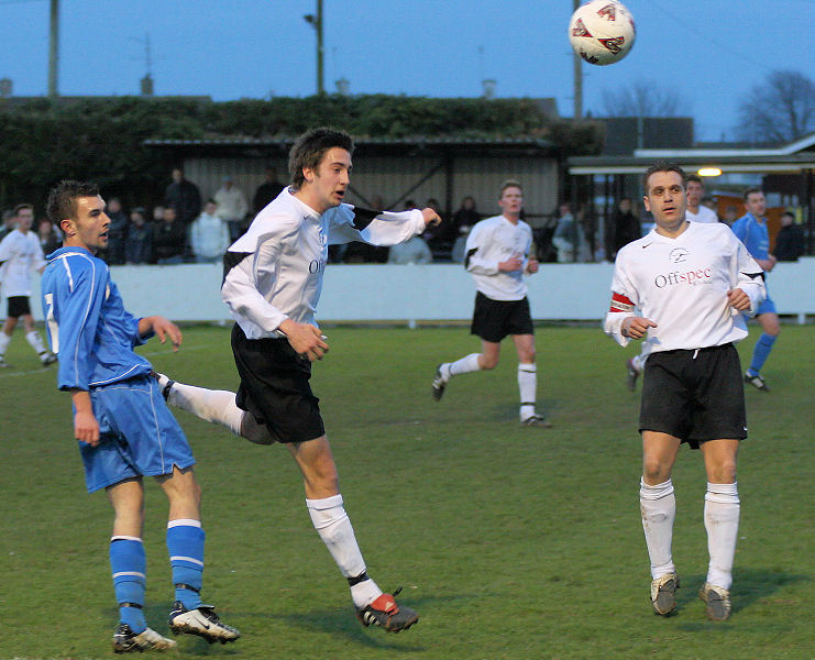 Chris Watton beats Peter Baker to head the ball out
