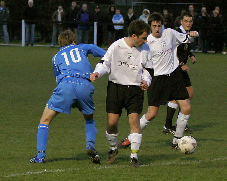 Michael Bush (10) tries get past Andy Beaumont to reach Chris Watton
